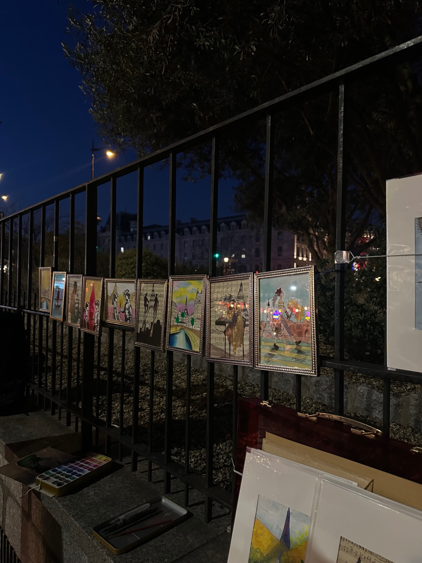 Painters along the Seine after dark
